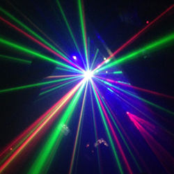Several lasers and lights at a dance party